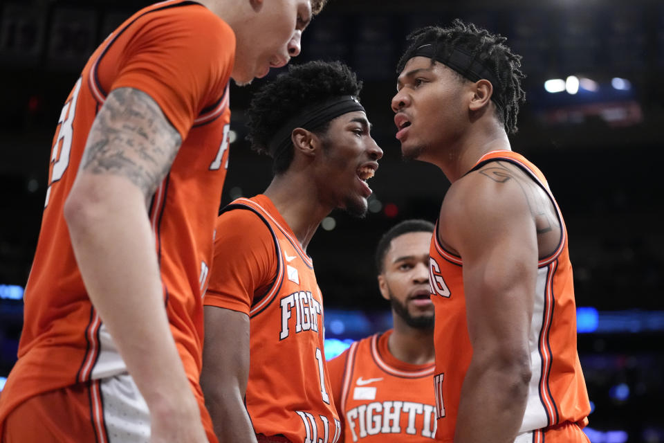 Illinois' Terrence Shannon Jr., right, reacts after scoring and drawing a foul in overtime during the team's NCAA college basketball game against Texas in the Jimmy V Classic, Tuesday, Dec. 6, 2022, in New York. (AP Photo/John Minchillo)