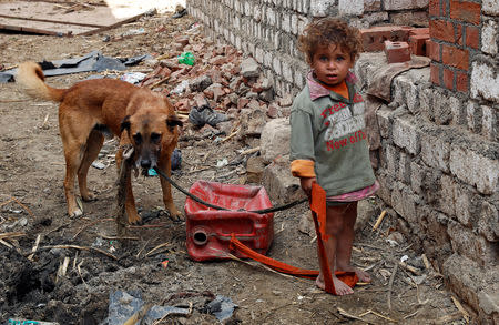 An Egyptian girl plays with her dog in the province of Fayoum, southwest of Cairo, Egypt February 19, 2019. Picture taken February 19, 2019. REUTERS/Hayam Adel