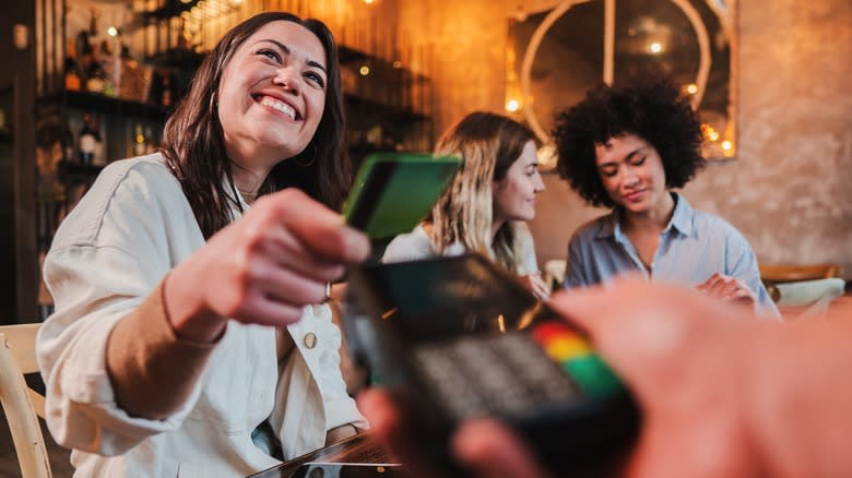 woman paying restaurant bill