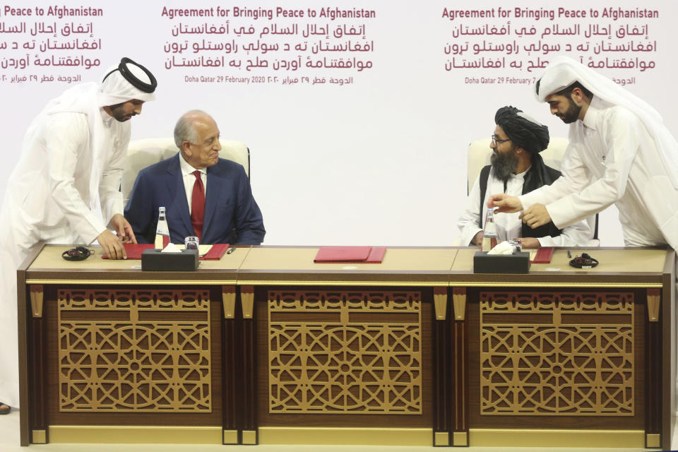 FILE - In this Feb. 29, 2020, file photo, U.S. peace envoy Zalmay Khalilzad, left, and Mullah Abdul Ghani Baradar, the Taliban group's top political leader sign a peace agreement between Taliban and U.S. officials in Doha, Qatar. The Taliban say the long-awaited peace talks with the negotiating team selected by the Afghan government are to begin on Saturday, Sept. 12, 2020, in the Gulf Arab state of Qatar. The announcement on Sept. 10, came in a statement from the Taliban in Qatar, where the insurgents maintain a political office, and also as an announcement from Qatar’s foreign ministry. (AP Photo/Hussein Sayed, File)