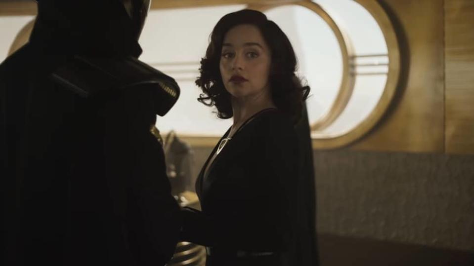 Emilia Clarke as Qi'ra wearing a black dress in Solo: A Star Wars Story