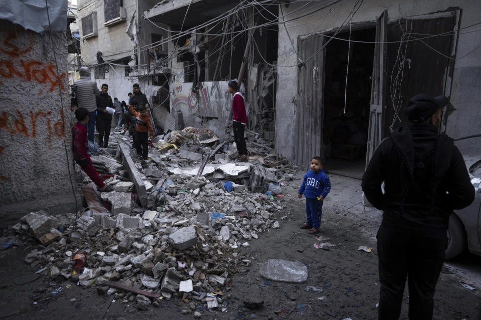 Palestinians look at the destruction after an Israeli strike in Rafah, southern Gaza Strip, Wednesday, Jan. 17, 2024. (AP Photo/Fatima Shbair)