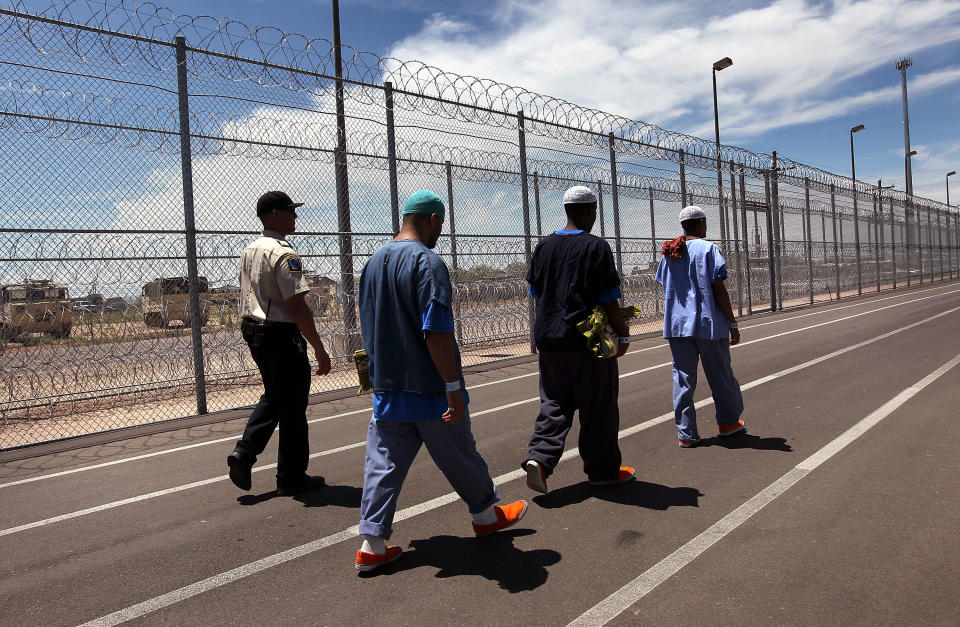 A guard escorts immigrants from Afghanistan, Somalia and Yemen ahead of a Friday Muslim prayer service at the U.S. Immigration and Customs Enforcement (ICE) detention facility in July 2010 in Florence, Arizona. (Photo: John Moore/Getty Images)