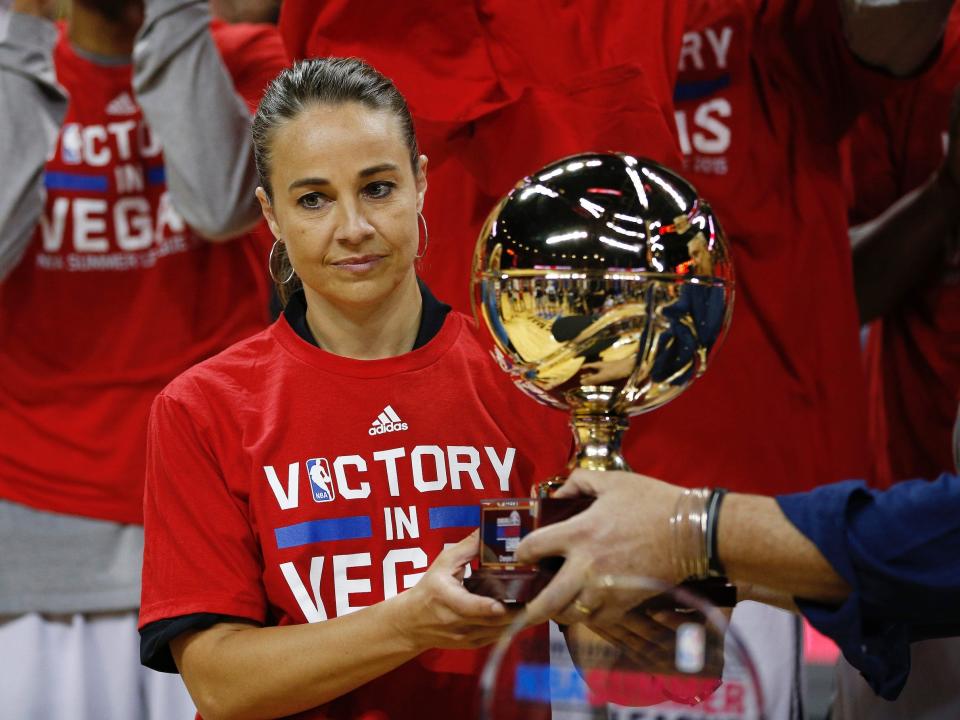 Becky Hammon receives the NBA Summer League trophy.