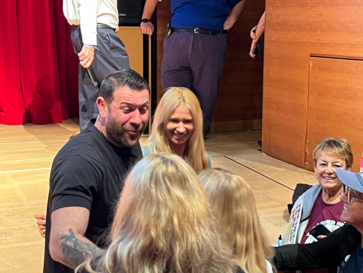 Renown animal rescue icon Lee Asher speaks to well wishers after a talk at Lynn University.