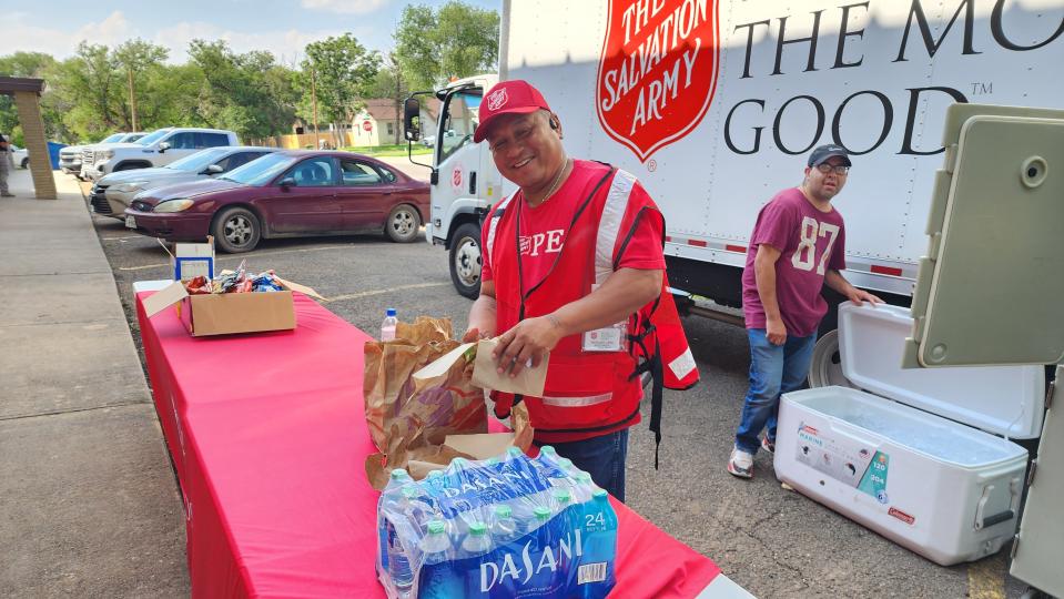 A Salvation Army worker hands out food Tuesday at the First Baptist Church in Hereford