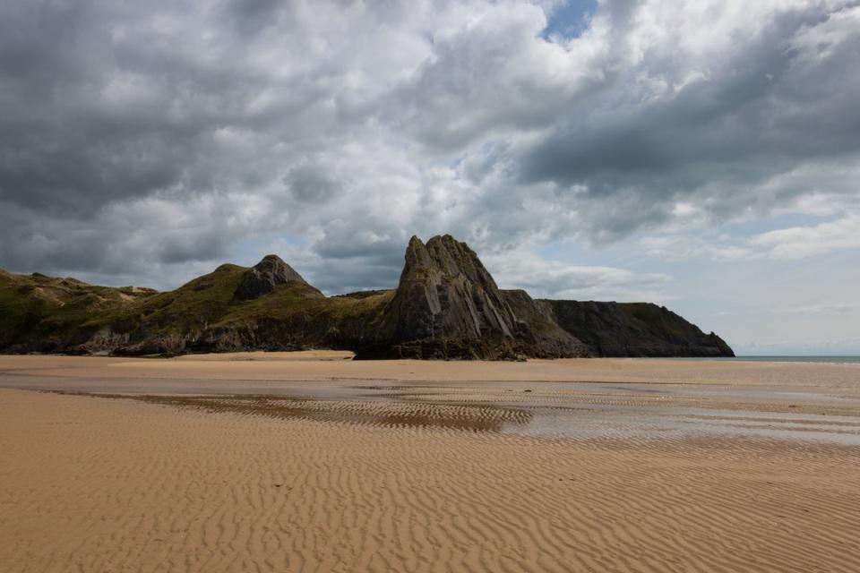 The dramatic landscape of Three Cliffs Bay is reminiscent of some of Europe’s best beaches (Getty Images)