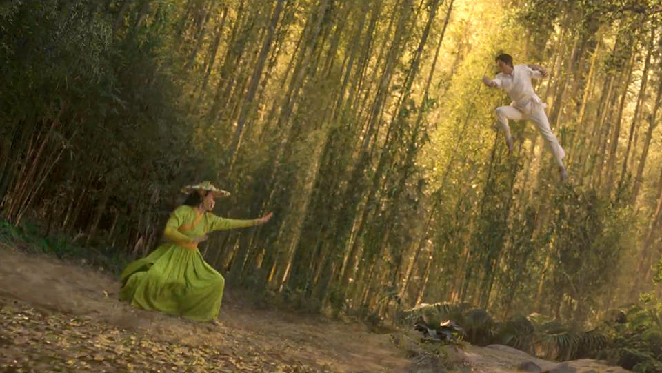 A woman in a green outfit fighting a man in the Shang-Chi trailer