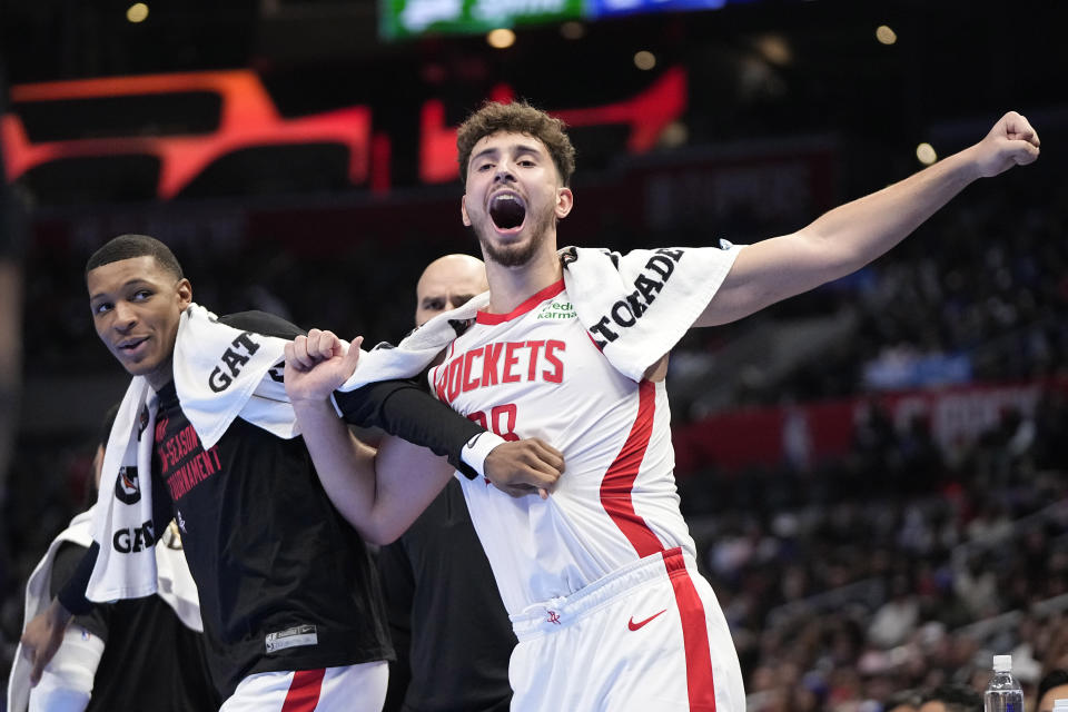 Houston Rockets forward Jabari Smith Jr., left, and center Alperen Sengun celebrate from the bench after they the Rockets scored during the second half of an NBA basketball In-Season Tournament game against the Los Angeles Clippers Friday, Nov. 17, 2023, in Los Angeles. (AP Photo/Mark J. Terrill)