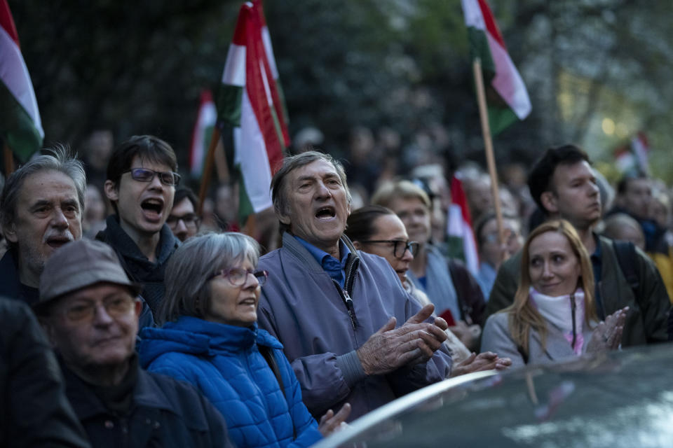 People listen to the speech of former Hungarian government insider Peter Magyar next to Kossuth Square on Tuesdy, in Budapest, Hungary, March 26, 2024. Magyar on Tuesday released a recording that he claims proves senior officials in the government of Prime Minister Viktor Orban manipulated court documents to cover up their involvement in a corruption case. (AP Photo/Denes Erdos)