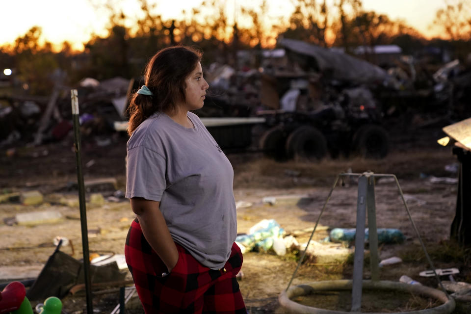 Katelyn Smith watches after her one-year old son Ricky Trahan III, amidst the rubble of the family's destroyed home in Lake Charles, La., Friday, Dec. 4, 2020. They were hit by Hurricanes Laura and Delta. Her future in-laws are living in a tent on the property, while she, her child and her fiancé Ricky Trahan, Jr., are living in a loaned camper. A relatives home on the same property is now gutted and they are living in a camper as well. (AP Photo/Gerald Herbert)