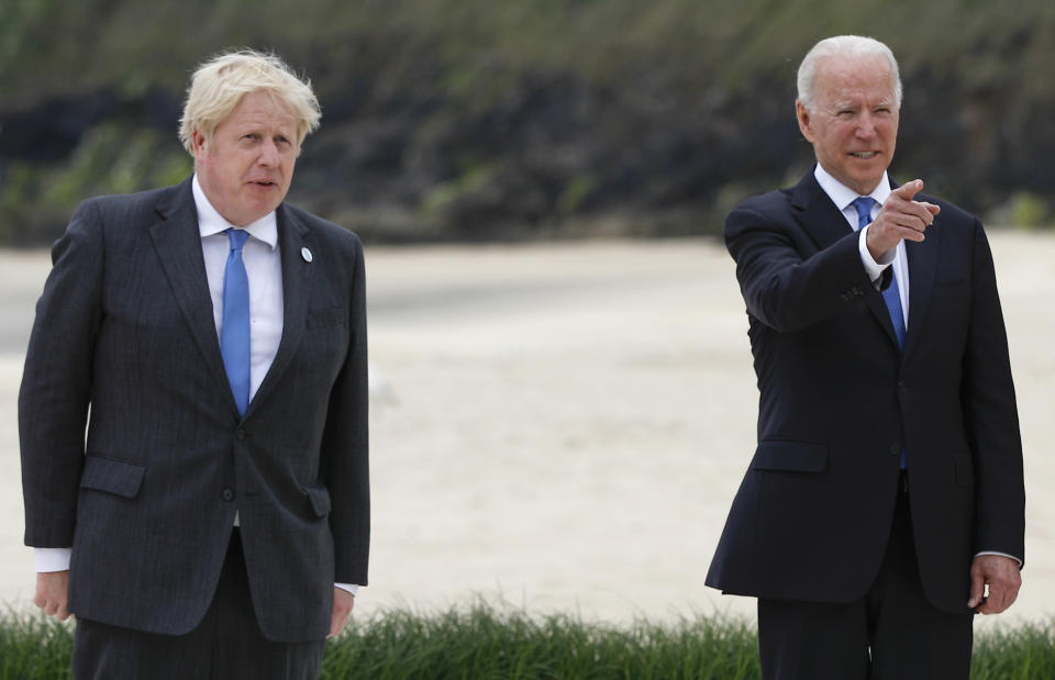 Britain's Prime Minister Boris Johnson poses with U.S. President Joe Biden during arrivals for a G7 meeting at the Carbis Bay Hotel in Carbis Bay, St. Ives, Cornwall, England, Friday, June 11, 2021. Leaders of the G7 begin their first of three days of meetings on Friday, in which they will discuss COVID-19, climate, foreign policy and the economy. (Phil Noble, Pool via AP)