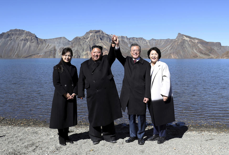 FILE - In this Sept. 20, 2018 file photo, South Korean President Moon Jae-in, second from right, and his wife Kim Jung-sook, right, stand with North Korean leader Kim Jong Un, second from left, and his wife Ri Sol Ju on the Mount Paektu in North Korea. To hear a beaming Donald Trump at his June summit with Kim Jong Un in Singapore, the solution to North Korea’s headlong pursuit of nuclear weapons, a foreign policy nightmare that has flummoxed U.S. leaders since the early 1990s, was at hand. (Pyongyang Press Corps Pool via AP, File)