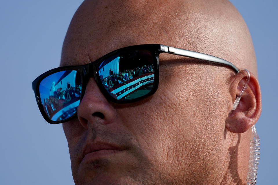 Supporters of President Donald Trump are reflected in the glasses of a U.S. Secret Service agent during a campaign rally at Dayton International Airport, Sept. 21, 2020.<span class="copyright">Alex Brandon—AP</span>