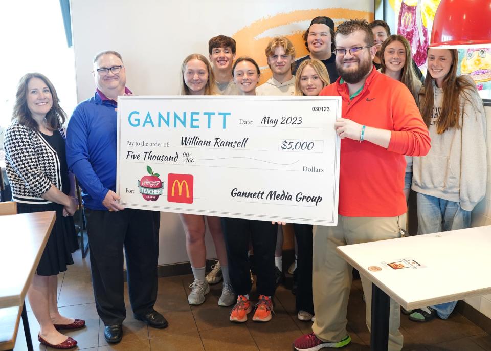 Tecumseh High School teacher Will Ramsell, front right, is presented a ceremonial check Wednesday at the U.S. 223 McDonald's in Adrian by Kim Zimmerman of Gannett and Mike Bodman, Adrian McDonald's owner, for being named Gannett's “Amazing Teacher of the Month” for May. Also pictured are several Tecumseh High School students.