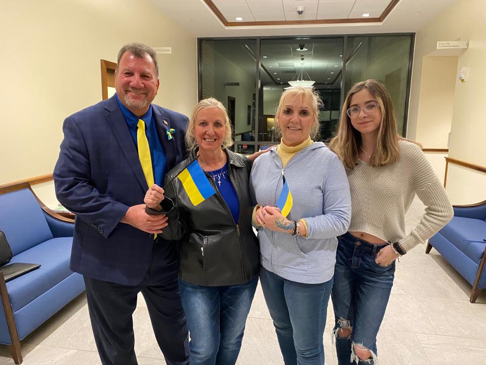 Pegi Conte, her sister Lily Souza and several other supporters went before the Taunton City Council on March 15 to offer handmade yellow and blue ribbon pins with the colors of the Ukrainian flag and to ask for a declaration of public support and solidarity from the city. From left, Councilor John McCaul, Elaine Heshion, Pegi Dran Conte and Payge Peixoto.