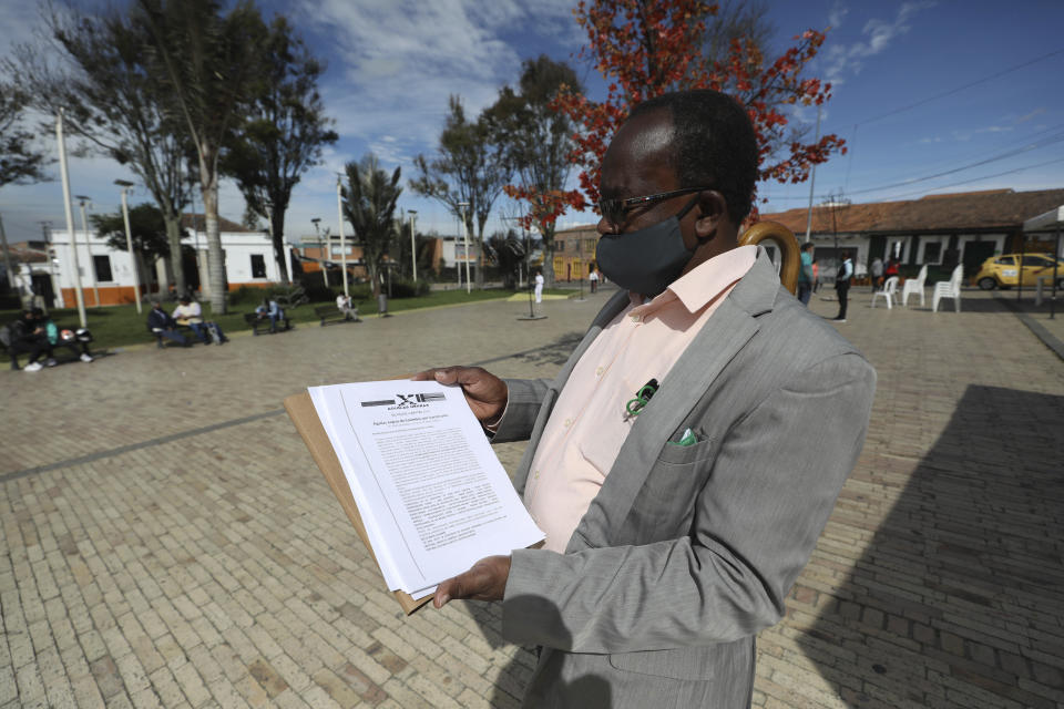 Community leader Baldoino Asprilla shows a death threat that was sent to him, during an interview in Bogota, Colombia, Thursday, Dec. 17, 2020. Last year 120 community leaders were murdered in Colombia according to the U.N.’s High Commissioner for Human Rights, up from 107 a year earlier. (AP Photo/Fernando Vergara)