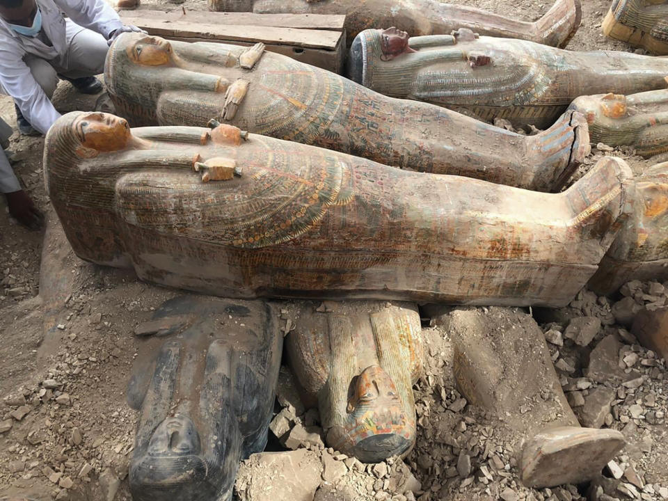 This photo provided by the Egyptian Ministry of Antiquities shows recently discovered ancient colored coffins with inscriptions and paintings, in the southern city of Luxor, Egypt, Tuesday, Oct. 15, 2019. The ministry said archeologists found at least 20 wooden coffins in the Asasif Necropolis, describing it as one of the “biggest and most important” discoveries in recent years. (Egyptian Ministry of Antiquities via AP)