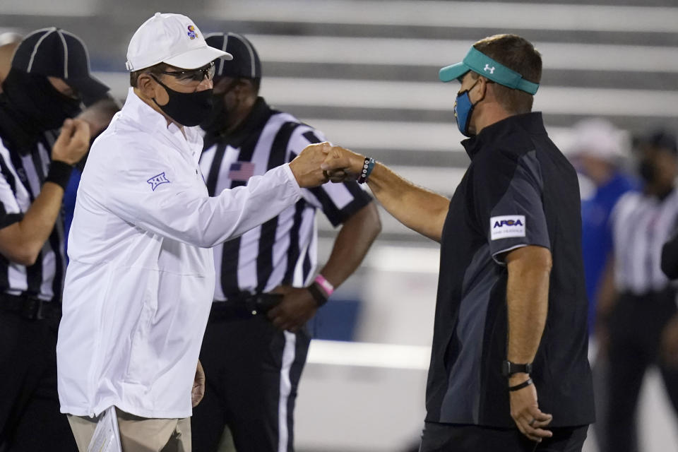 Kansas head coach Les Miles, left, greets Coastal Carolina head coach Jamey Chadwell before an NCAA college football game in Lawrence, Kan., Saturday, Sept. 12, 2020. (AP Photo/Orlin Wagner)