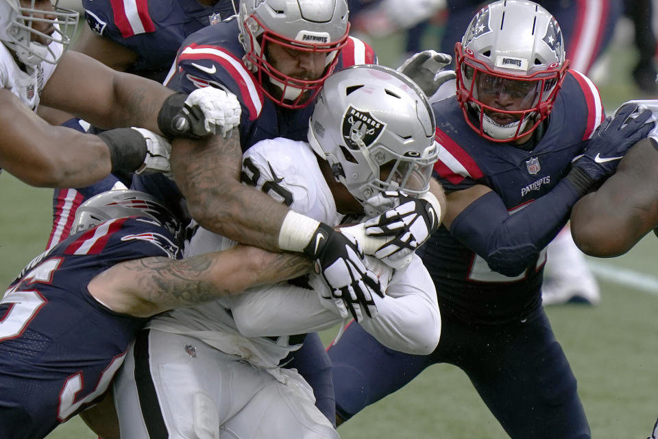 New England Patriots defenders combine to tackle Las Vegas Raiders running back Josh Jacobs (28) in the first half of an NFL football game, Sunday, Sept. 27, 2020, in Foxborough, Mass. (AP Photo/Steven Senne)