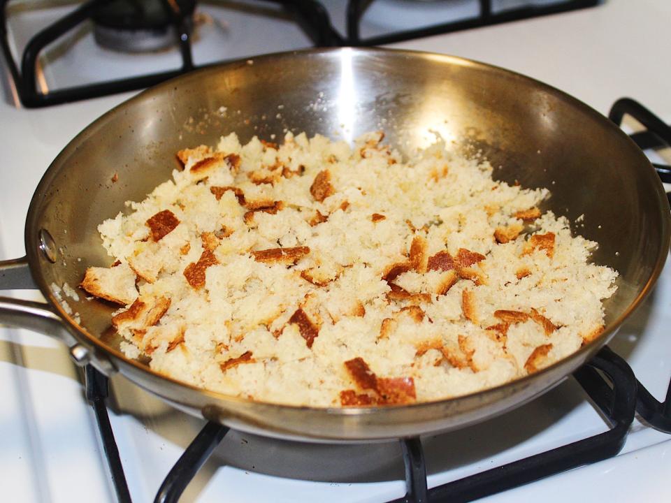 homemade breadcrumbs toasting in stainless steel pan