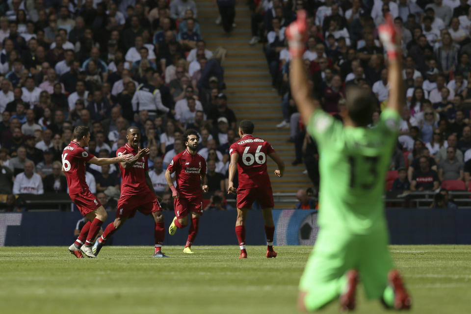 Liverpool's Georginio Wijnaldum, 2nd from left, reacts as he celebrates with team members after scoring his side opening goal during the English Premier League soccer match between Tottenham Hotspur and Liverpool at Wembley Stadium in London, Saturday Sept. 15, 2018. (AP Photo/Tim Ireland)
