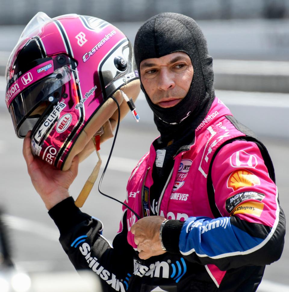 Meyer Shank Racing driver Hélio Castroneves (06) takes off his helmet after getting out of his car on Wednesday, May 17, 2023, during the second day of practice for the Indianapolis 500 at Indianapolis Motor Speedway. 