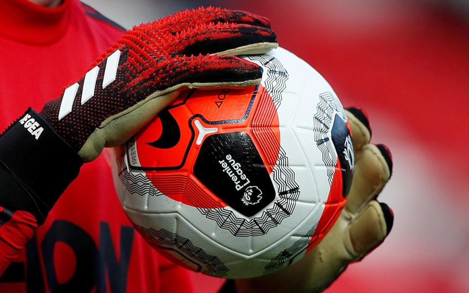 General view of a match ball held by Manchester United's David de Gea during the warm up before the match  - ACTION IMAGES