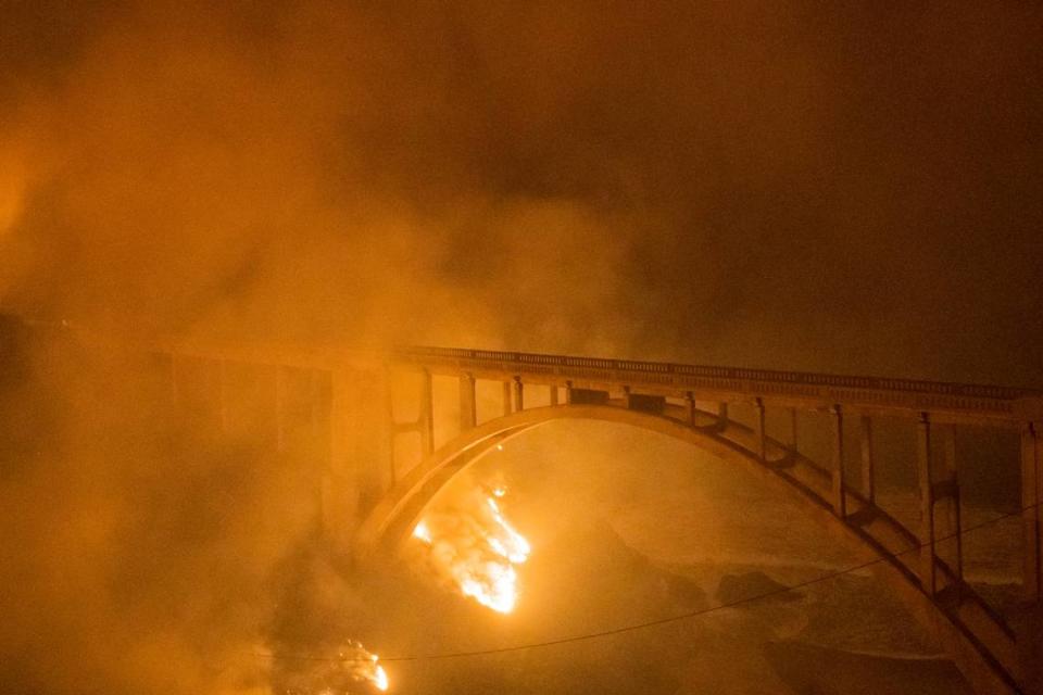 The Colorado Fire burns along below Rocky Creek Bridge on Highway 1 near Big Sur, Calif., Friday, Jan. 21, 2022. (AP Photo/Nic Coury)