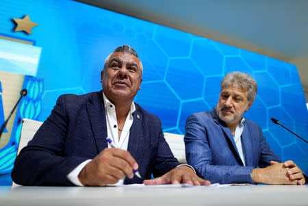 Claudio Tapia, president of the Argentine Football Association (AFA) signs the professionalization contract of the women's soccer league next to Sergio Marchi, General Secretary of the Argentina's Footballers' Union (FAA), in Buenos Aires, Argentina. March 16, 2019. REUTERS/Agustin Marcarian