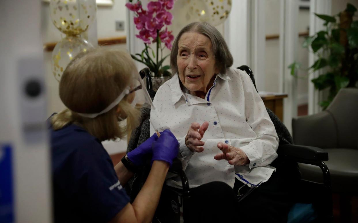 Care home resident Joan Potts, aged 102 speaks to Dr. Jane Allen before receiving her first dose of the Oxford/AstraZeneca COVID-19 vaccine - Matt Dunham/AP