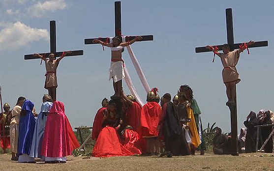 Three penitents are nailed to crosses during the Easter Friday ceremony - Credit: APTN