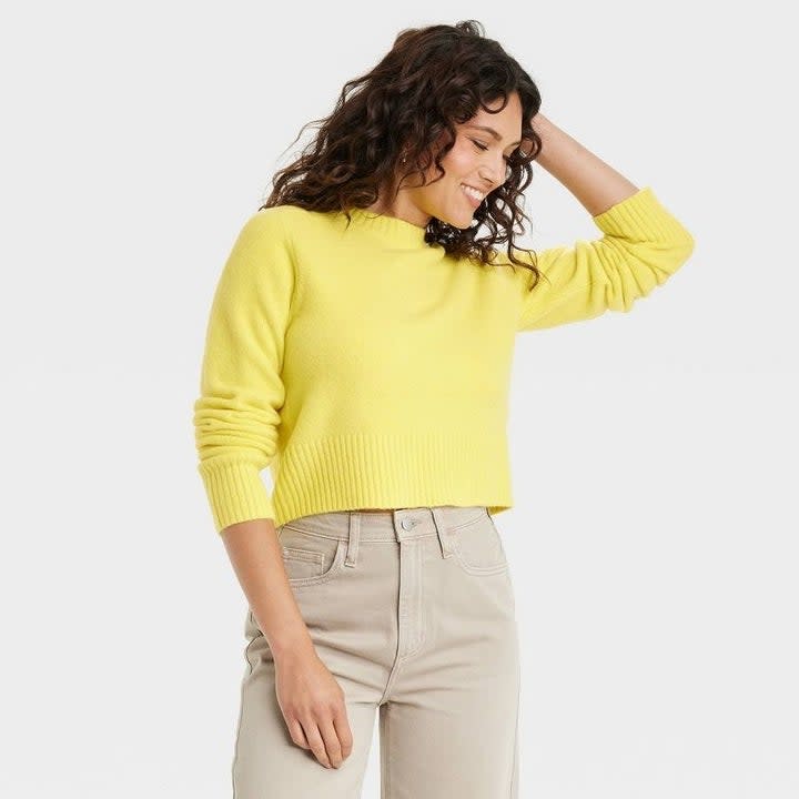 Model wearing the yellow sweater