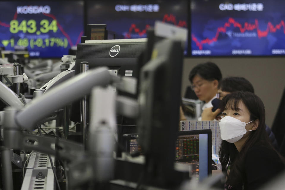 A currency trader watches monitors at the foreign exchange dealing room of the KEB Hana Bank headquarters in Seoul, South Korea, Friday, Nov. 6, 2020. Asian stock markets were mixed Friday after Wall Street rose amid protracted vote-counting following this week's U.S. elections. (AP Photo/Ahn Young-joon)