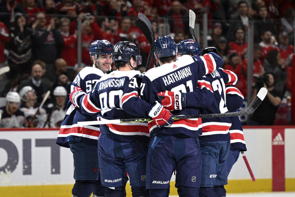 Washington Capitals players celebrate defenseman Erik Gustafsson first period goal during an NHL hockey game against the Columbus Blue Jackets, Sunday, Jan. 8, 2023, in Washington. (AP Photo/Terrance Williams)