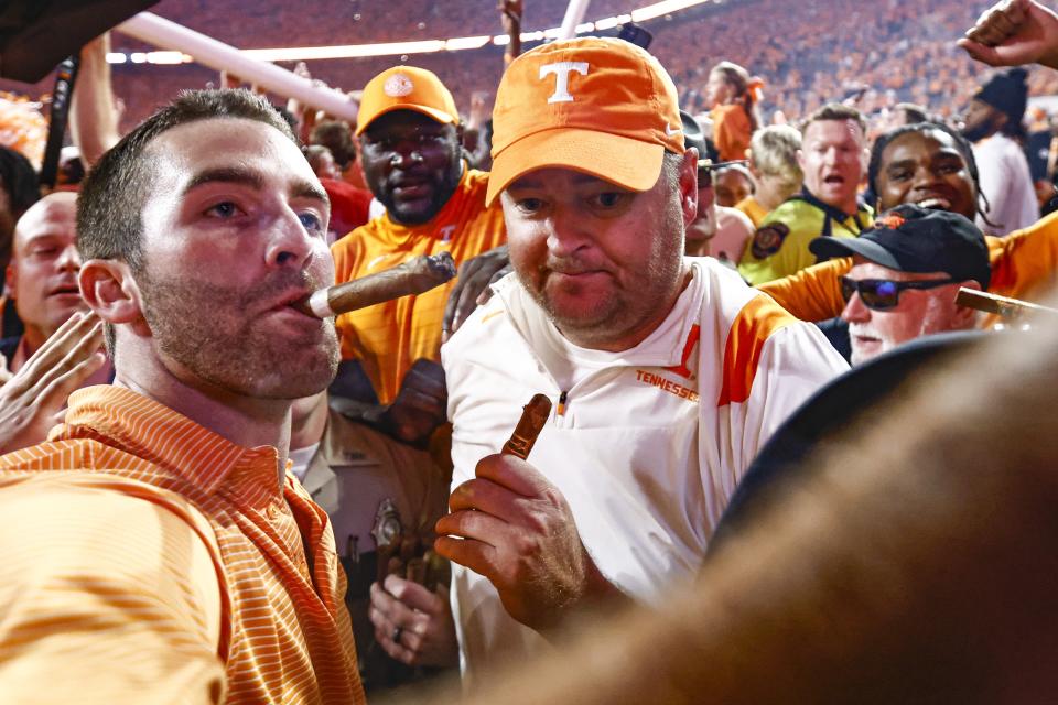 Tennessee head coach Josh Heupel, center, leaves the field after his team defeated Alabama 52-49 in an NCAA college football game Saturday, Oct. 15, 2022, in Knoxville, Tenn. (AP Photo/Wade Payne)