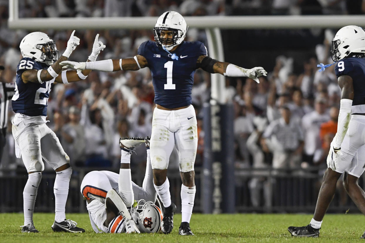 FILE - Penn State safety Jaquan Brisker (1) and cornerback Daequan Hardy (25) celebrate an incomplete pass against Auburn during an NCAA college football game in State College, Pa., in this Saturday, Sept. 18, 2021, file photo. Brisker was selected to The Associated Press Midseason All-America team, announced Tuesday, Oct. 19, 2021. (AP Photo/Barry Reeger, File)