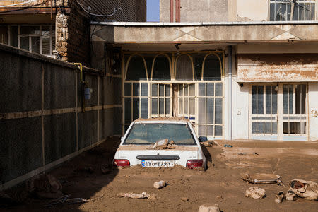 FILE PHOTO: A car half-covered with mud is seen at a house in Lorestan province, Iran, April 4, 2019. Khashayar Javanmardi/Tasnim News Agency/via REUTERS/File Photo