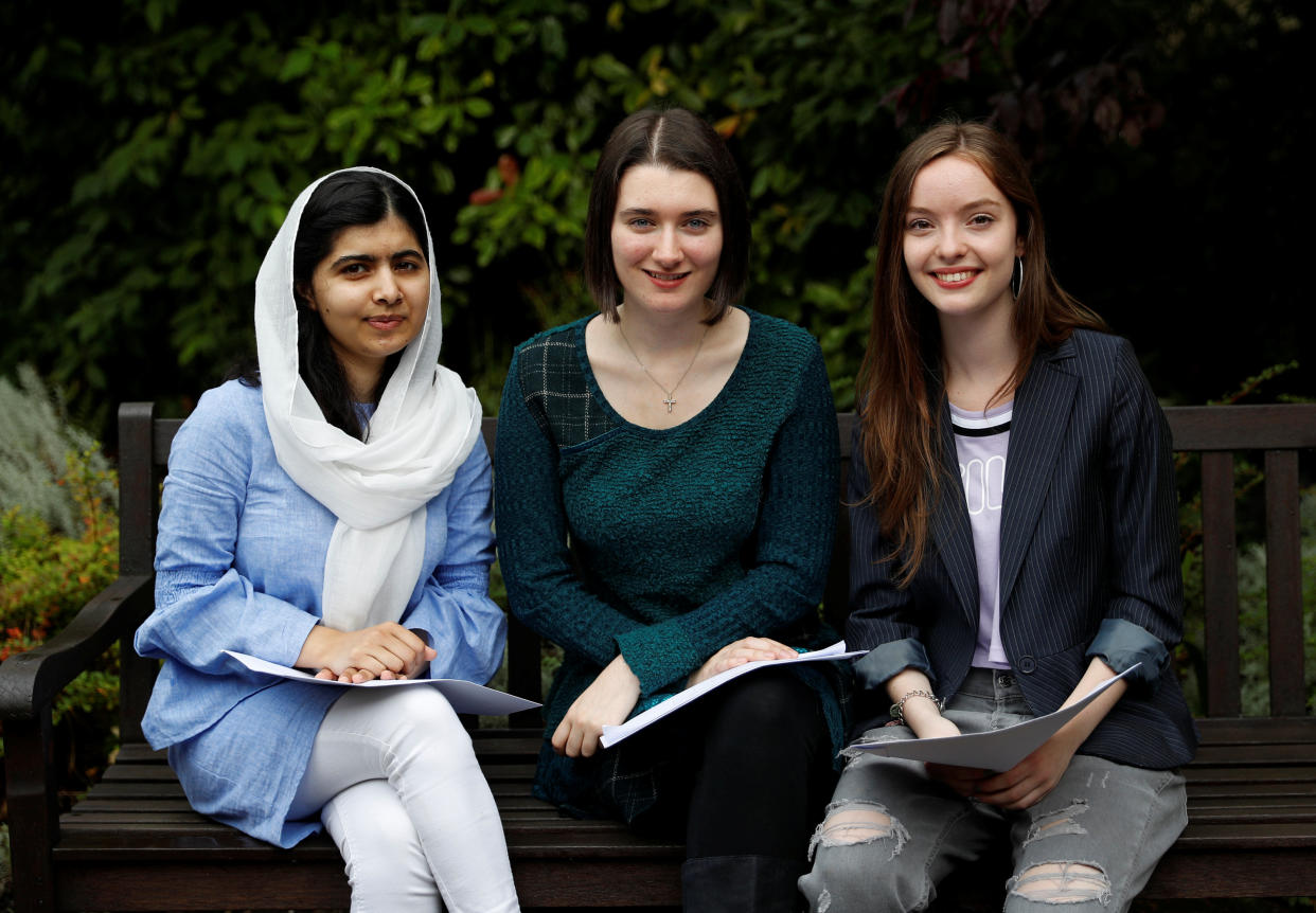 Malala Yousafzai (L) poses with fellow students Bethany Lucas (C) and Beatrice Kessedjian after collecting her ‘A’ level exam results at Edgbaston High School for Girls in Birmingham, Britain August 17, 2017. REUTERS/Darren Staples