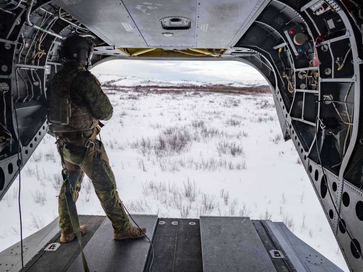 A Canadian Armed Forces member is pictured on a reconnaissance flight during a training exercise at Fort Wainwright, Alaska, in March. (Corporal Angela Gore/Canadian Armed Forces - image credit)