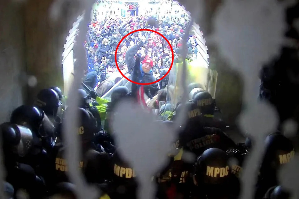 FILE - In this image from U.S. Capitol Police security video, released and annotated by the Justice Department in the Statement of Facts supporting an arrest warrant, Shane Jenkins, circled in red, is seen holding an object near the Lower West Terrace tunnel at the U.S. Capitol on Jan. 6, 2021, in Washington. Jenkins was sentenced to seven years in prison. (Justice Department via AP)