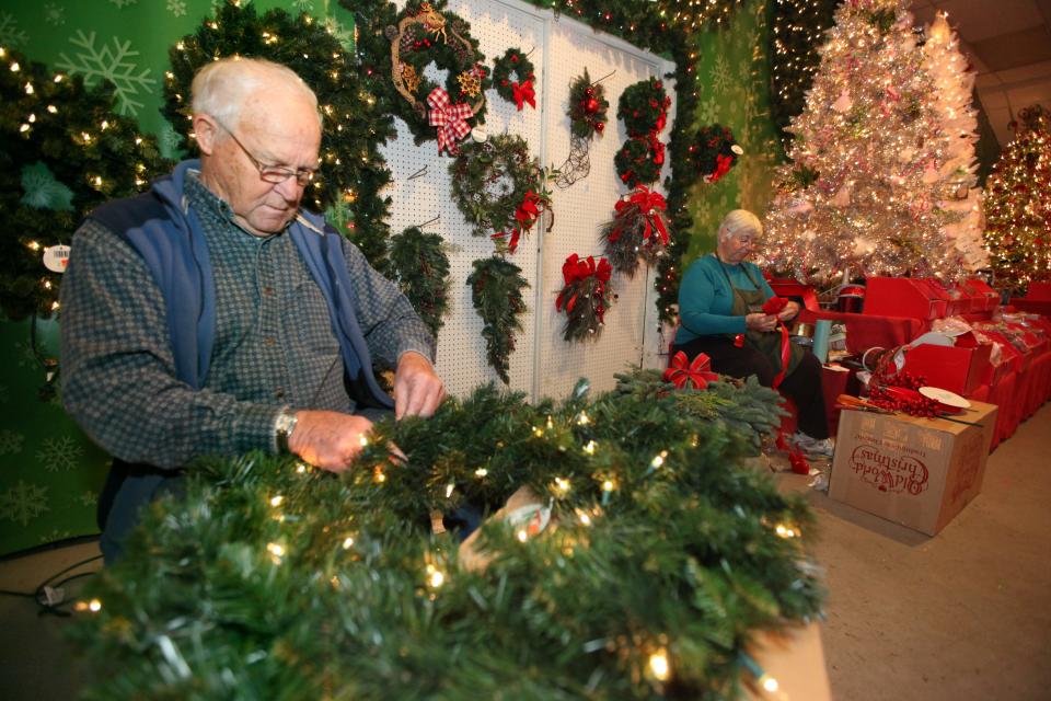 134928 BERGEN; CRESSKILL 12/2/2014 Norbert Pendergast Sr. and his wife Pat Pendergast of Cresskill work on holiday decorations Tuesday in Cresskill. After almost 90 years, the Willow Run Nursery & Garden Center in Cresskill will be closing its doors. Tuesday December 2, 2014. STAFF PHOTO BY; KEVIN R. WEXLER