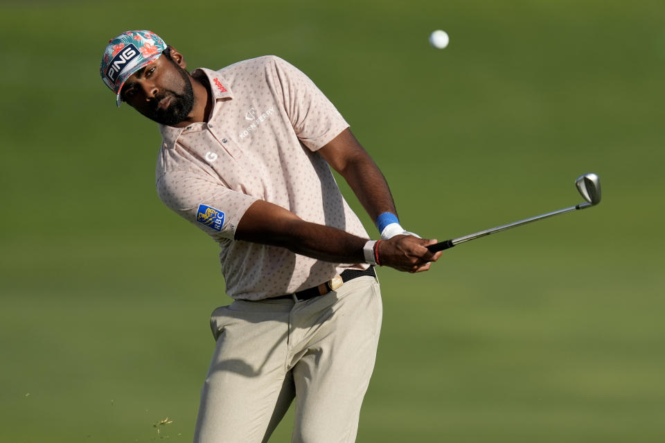 Sahith Theegala hits his approach shot form the 18th fairway during the first round of The Sentry golf event, Thursday, Jan. 4, 2024, at Kapalua Plantation Course in Kapalua, Hawaii. (AP Photo/Matt York)