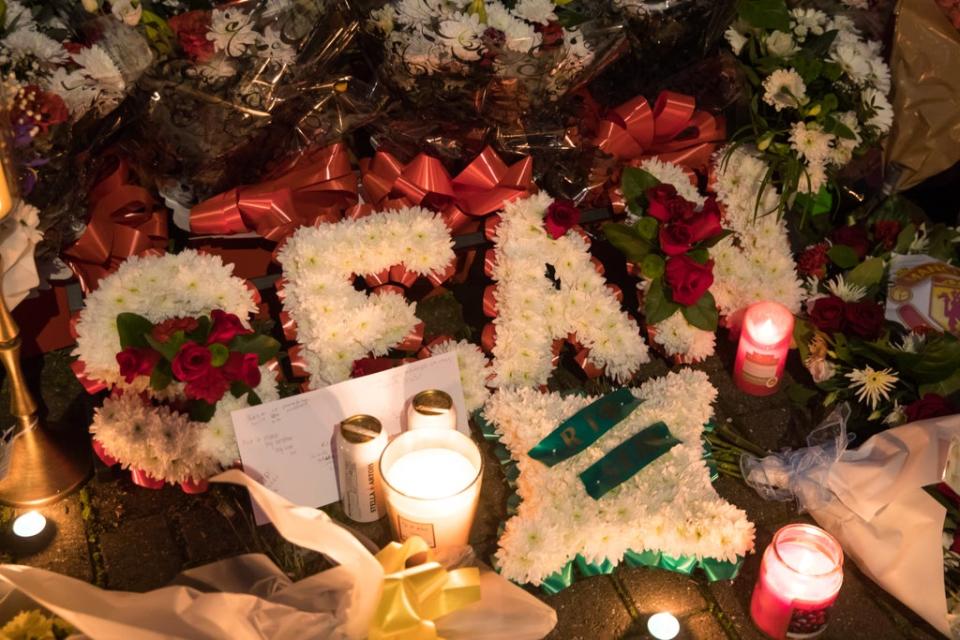 Floral tributes are left at a house on Burnaby Road in Coventry (PA) (PA Archive)