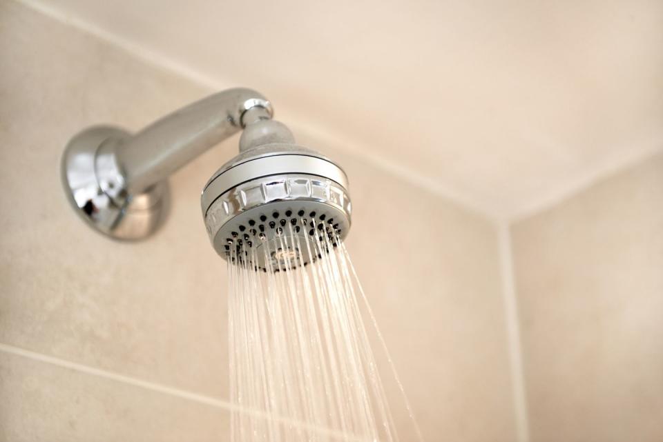 <p>A clogged showerhead impacts your water pressure, which results in a less-efficient shower that can cause you to run out of hot water quicker (not fun in the winter!). “Use a sturdy plastic bag large enough to fit over the showerhead,” says Bidwell. “Place the bag around the showerhead and fill it with white or apple cider vinegar while holding it in place. Allow the head to soak in the vinegar for at least 12 hours. If it’s brass, gold or nickel-coated showerheads, be sure to only soak for 30 minutes. After the showerhead has soaked, remove the bag and pour the vinegar down the drain. Turn on the shower and run hot water through the head to remove any loose mineral deposits. Use a toothpick and an old toothbrush to scrub the water ports and knock off any stuck-on buildup.</p>