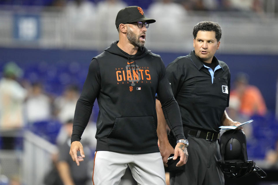 San Francisco Giants manager Gabe Kapler, left, talk with home plate umpire Charlie Ramos during the seventh inning of a baseball game against the Miami Marlins, Wednesday, April 19, 2023, in Miami. (AP Photo/Lynne Sladky)