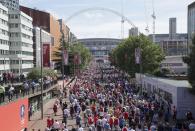 FILE - In this Saturday, May 27, 2017 file photo, people walk towards Wembley Stadium ahead of the FA Cup final soccer match between Arsenal and Chelsea, in London. The British government faced accusations of mixed messaging Wednesday June 23, 2021, that could threaten its plan to fully lift lockdown restrictions in England next month after it decided to allow more than 60,000 people inside Wembley Stadium for the latter stages of soccer's European Championship. (AP Photo/Tim Ireland, File)