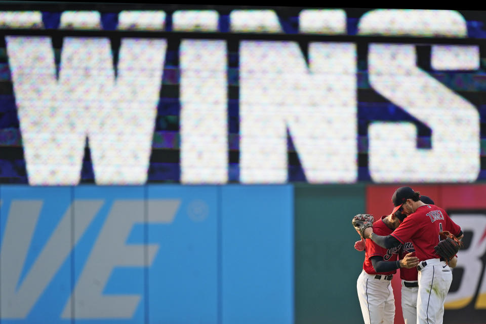 Cleveland Indians' Bradley Zimmer, Oscar Mercado, and Myles Straw hug after they defeated the Los Angeles Angels in a baseball game, Saturday, Aug. 21, 2021, in Cleveland. (AP Photo/Tony Dejak)