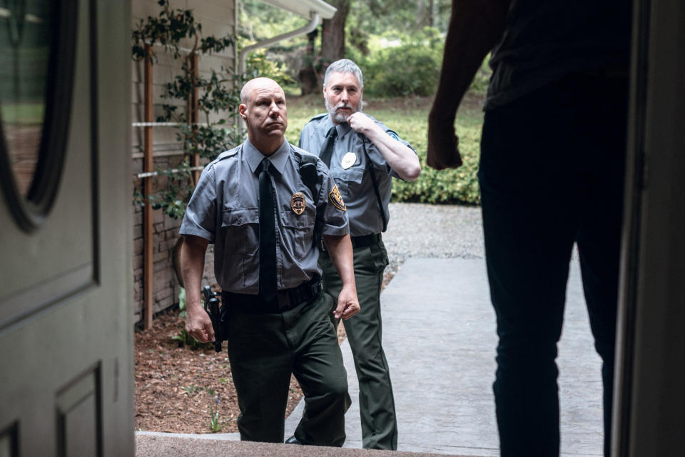 Police officers entering a house