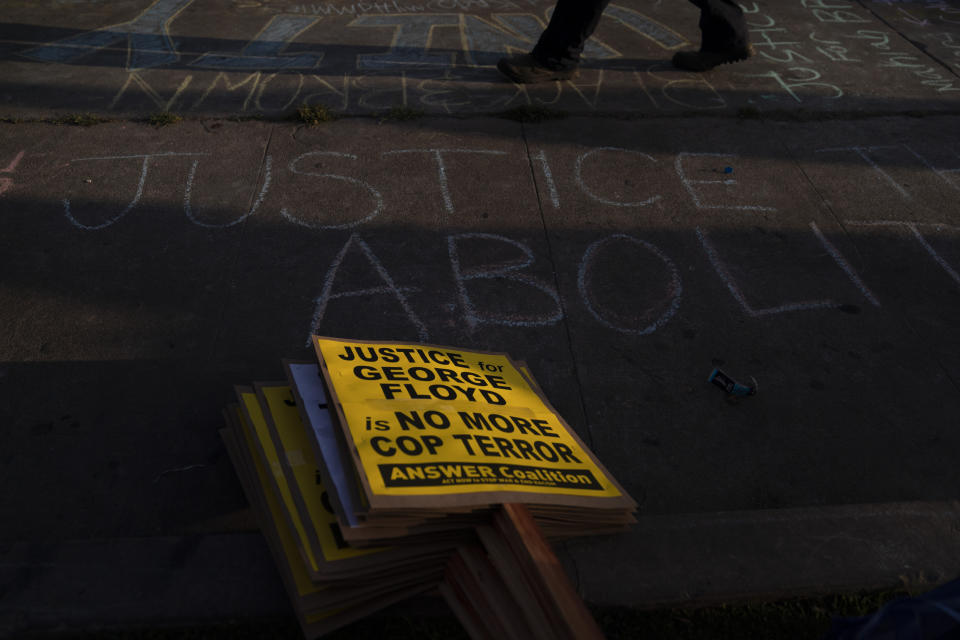 Protest signs are stacked on a sidewalk near the intersection of Florence and Normandie Avenues in Los Angeles, Tuesday, April 20, 2021, after a guilty verdict was announced at the trial of former Minneapolis police Officer Derek Chauvin for the 2020 death of George Floyd. (AP Photo/Jae C. Hong)